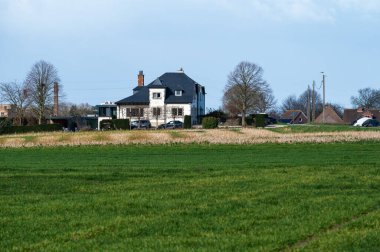 Farmhouse surrounded by green fields around Kobbegem, Flemish Brabant Region, Belgium
