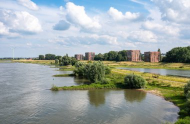 Nijmegen, Gelderland, The Netherlands, July 11, 2024 - Urbanised  banks of the Lower Rhine river clipart