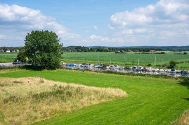 Heumen, Gelderland, The Netherlands, July 11, 2024 - High angle view over green meadows and a pleasure harbour clipart