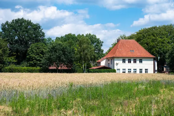 stock image Cloppenburg, Lower Saxony, Germany, June 15, 2024 - Old commercial Anton Hoffhaus house, now a country house surrounded with agriculture fields