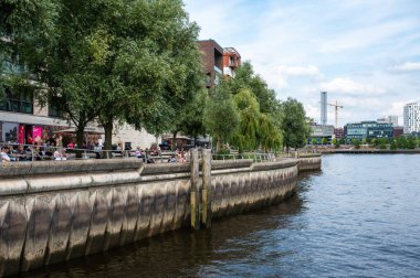 Hamburg, Germany, July 18, 2024 - Lively docks with people and restaurants in the Hafencity clipart