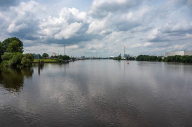 Hamburg, Germany, July 18, 2024 - Cityscape view over nature and industrial acitivity at the river Elbe clipart