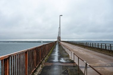 Storstrommen, Seeland, Denmark, July 22, 2024 - Road and railway arch bridge that crosses Storstormmen between the islands of Falster and Masned in Denmark. clipart