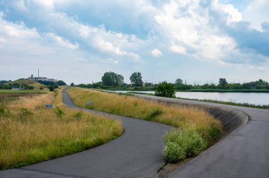 Empty asphalt cycling path at the Brondby strandpark, Copenhagen, Denmark clipart