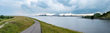 Copenhagen, Demark, July 23, 2024 - View over the bay of Koge and a cycling path clipart