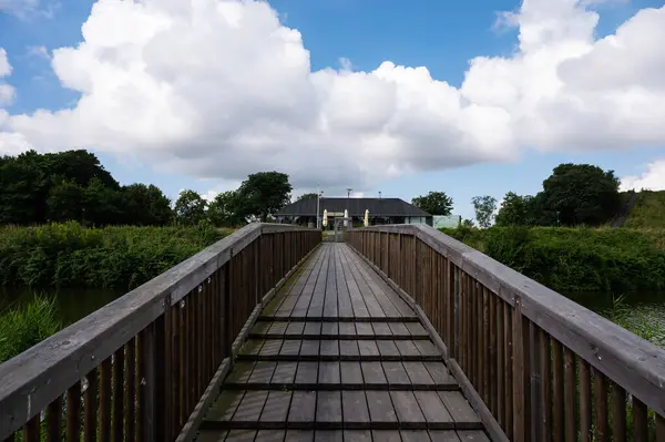 stock image Copenhagen, Denmark, July 24, 2024 - Wooden pedestrian bridge towards the Kastrup Fort