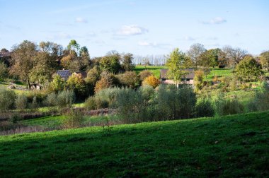 Houses in the green fields in Lennik, Flemish Brabant Region, Belgium clipart