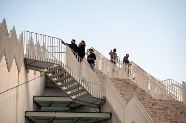 People at the top of the staris of the Pyramid of Tirana, Albania, DEC 7, 2024 clipart