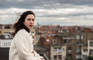 Açık havada, kahverengi saçlı, Brüksel, Belçika 'da bir çatı katında oturan 28 yaşında beyaz bir kadının portresi. Model bırakıldı