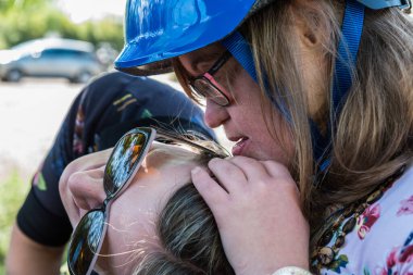 Portrait of a young white woman kissing a woman with Down Syndrome., Tienen, Flanders, Belgium. Model released clipart