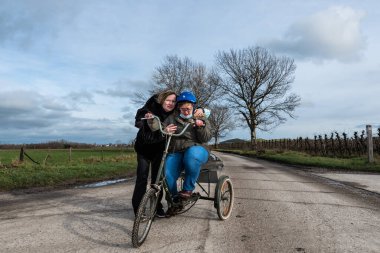 39 yo woman with Down Syndrome gettinga helping hand from her female friend, Tienen, Flanders, Belgium. Model released clipart