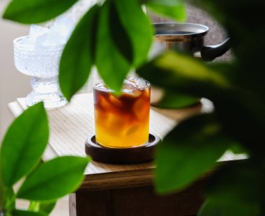 Karışık kahve. Portakal suyu, espresso, karamel şurubu ve buzdan yapılmış modaya uygun kahve içeceği. Ahşap masada bir bardak katmanlı kahve kokteyli, ev yapımı konsept. Kahve dükkanı mevsimlik menüsü, tarif