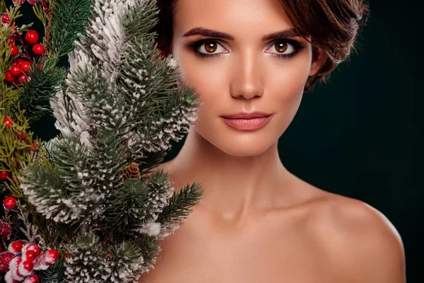 Aesthetic photo of pretty lovely lady newyear pine decor advertises cosmetics isolated on green color background.