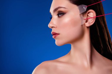 Profile side photo of stunning lady on cosmetician visit apply face lifting anti aging procedure on blue background. clipart