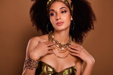 Photo of rich egyptian queen lady wear gold chain necklace for native theme party festival on brown color background. clipart