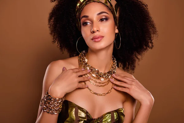 Photo of rich egyptian queen lady wear gold chain necklace for native theme party festival on brown color background.