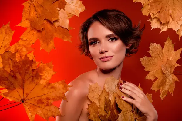 Photo of pretty lovely lady mother earth change dressing autumn brown maple leaves on red background.