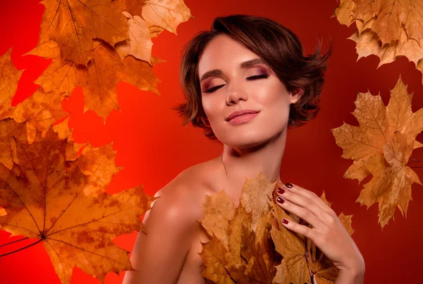 Photo of pretty lovely lady touch apply lotion on skin body with autumnal foliage ingredient over color background.