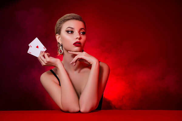 Photo of dreamy gorgeous lady dressed sexy outfit rising black jack cards empty space isolated maroon color background.