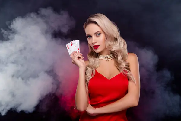 Photo of glossy fancy lady wear sexy dress rising two red aces playing cards isolated black color background.