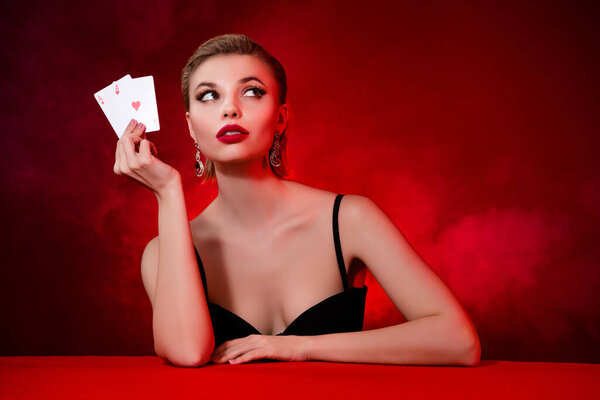 Photo of thoughtful dreamy lady dressed sexy outfit enjoy black jack empty space isolated red maroon color background.