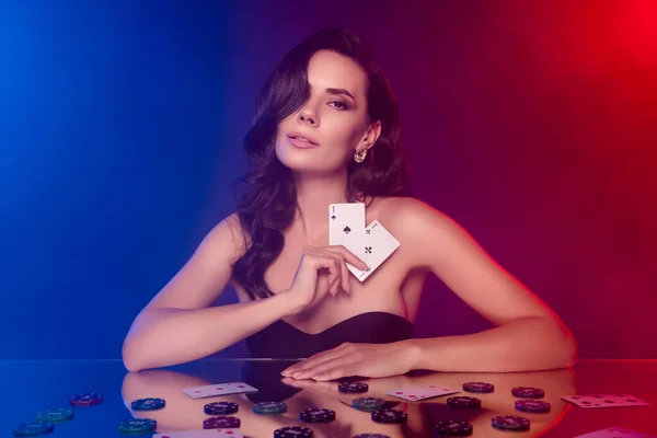 Photo of stunning chic lady in night neon club professional poker player with black jack cards over glass desk.
