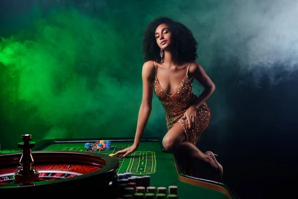 Photo of chic gorgeous lady lean poker table try bluff cheating professional playing guys on mist filter background.