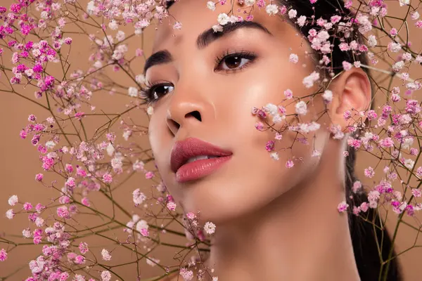 Close up photo of gentle lady aesthetic pure perfect skin facial floral mask cream isolated on beige color background.