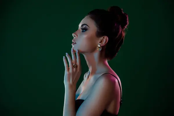 Profile photo of gorgeous lady in night club party wearing expensive diamonds rings isolated on green color background.