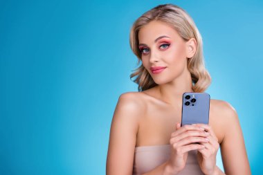 Photo of chic girlish lady on event occasion using cell smart phone promoting new electronics brand.