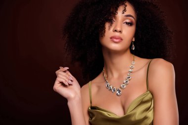 Portrait of attractive woman rich expensive lifestyle dressed stylish silky clothes isolated on brown color background.