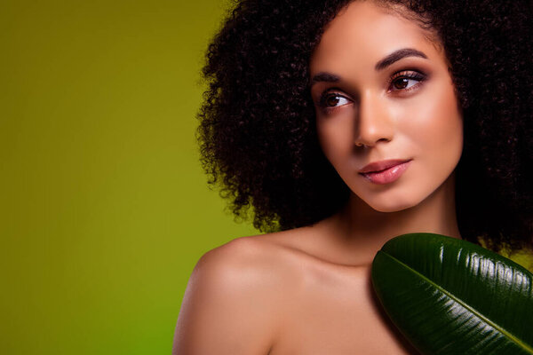 Photo of gorgeous stunning girl with palm leaf on chest look green empty space natural beauty product advert.
