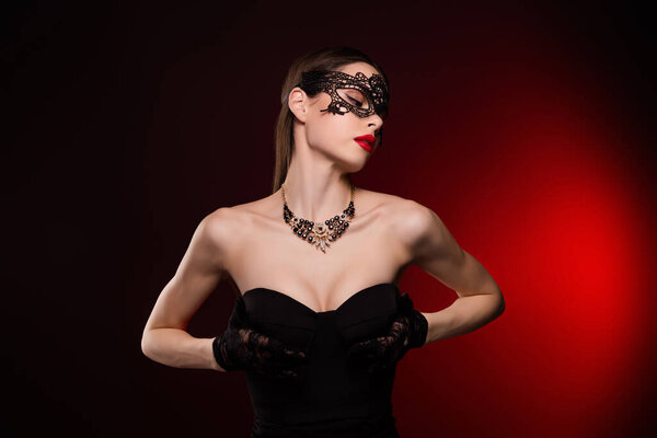 Photo of lady feel tempting passion touch black dress chest wear carnival mask isolated red color background.