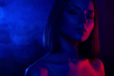 Kapalı gözlü güzel bir kızın fotoğrafı tutku hisset. Aşk arzusu izole edilmiş, sisli, renkli bir arka plan..