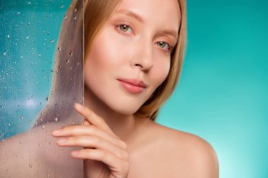 Photo of attractive model glass door take bath douche relax refreshment isolated on cyan color background.