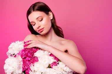 Dreamy tender girlfriend with closed eyes holding big bouquet enjoying fresh peonies empty space over pink background. clipart