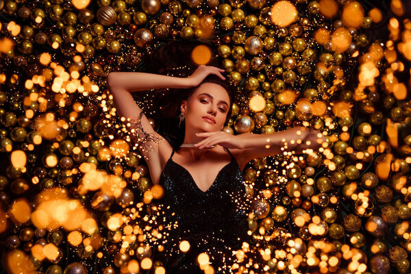 High view photo of classy fancy tender lady lying among balls variety christmas new year theme accessories.