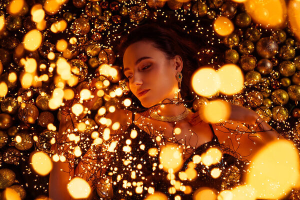 High view photo of stunning luxury lady lying on christmas new year theme accessories background.