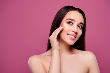 Çekici, çıplak kadın omuzlarının fotoğrafı cilt losyonu sür. Küçük, izole pembe bir arka plan..