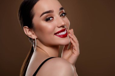 Çekici, siyah sutyen giymiş çekici bir kadının ekili fotoğrafı. Yüzeysel, izole edilmiş bej arka plan..