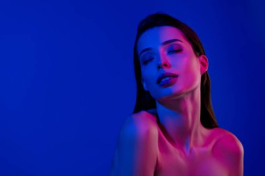 Photo of tender stunning lady with closed eyes enjoying taking douche over blue color background.