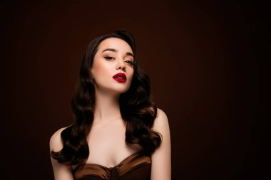 Kendine güvenen çekici bayan model lüks etkinlik partisinin fotoğrafı kahverengi arka planda izole edilmiş..