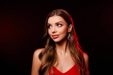 Koyu kırmızı arka planda izole edilmiş değerli aksesuarlar giyen alımlı muhteşem modelin portresi..