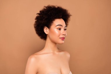 Çekici, nazik, çıplak omuzlu, bej renkli arka planda izole bir tenin fotoğrafı..