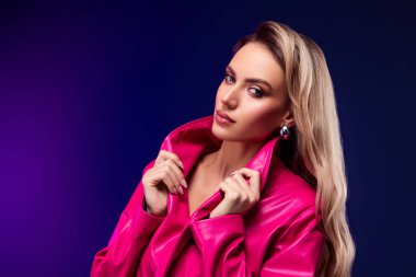 Büyüleyici özellikleri olan, canlı pembe bir trençkot giymiş, kendine güveni tam bir poz veren, entelektüel, kendine güveni ve modern modası olan muhteşem bir kadın..