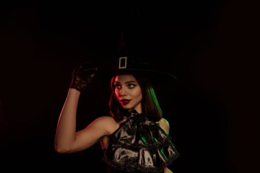 A captivating depiction of a witch in fashionable attire against a dark background, embodying Halloween mystique and fantasy allure.