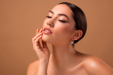 A captivating portrait of a young female model showcasing natural beauty, smooth skin, and a refined elegance. Ideal for promoting skincare, makeup, and beauty industries, featuring warm tones and professional styling.