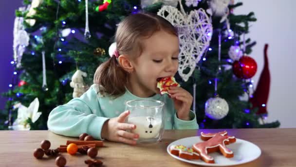 Little Curly Haired Girl Drinks Milk Glass Eats Gingerbread Christmas — Stock video