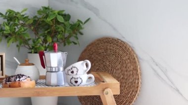 Romantic breakfast on a tray for International Womens Day. Coffee and fresh pastries for breakfast in bed for a loved one. Breakfast for two lovers. Slow motion.