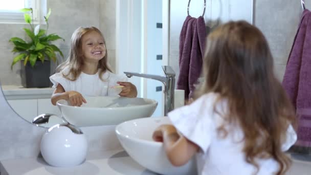 Uma Garotinha Escovando Dentes Banheiro Olhando Para Espelho Higiene Dentária — Vídeo de Stock